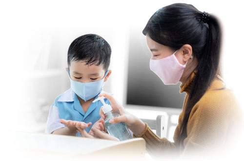 Teacher teaching a child to clean hands